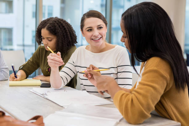 istock Woman takes notes as team members toss around ideas 1174446148