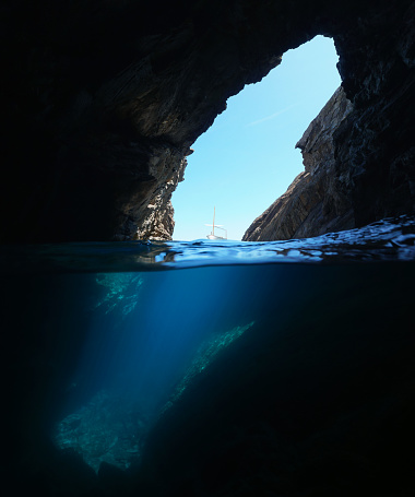 Over and under water inside a large cave on the sea shore, Spain, Mediterranean, Costa Brava, Cap de Creus, Cueva del infierno, Catalonia