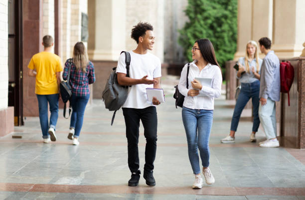 istock Diverse classmates chatting, walking after classes outdoors 1174446300