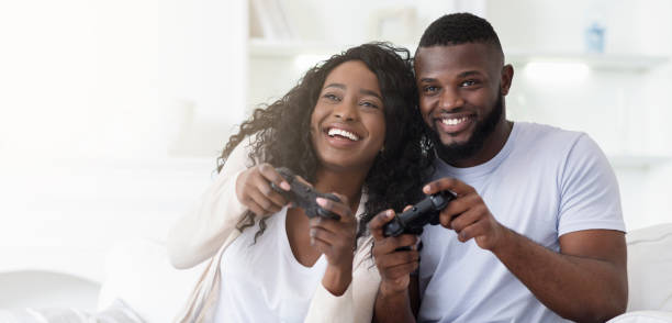 istock Playful millennial couple competing with each other in video game 1174446859