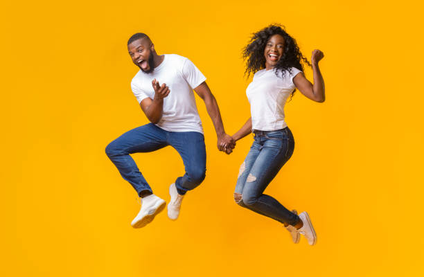istock Joyful african couple having fun over yellow background 1174447744