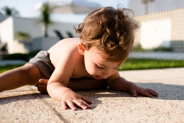 Baby boy near the ground shirtless