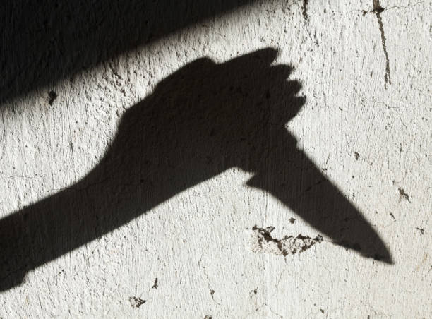 istock Shadow of the hand holding a knife 1174448330