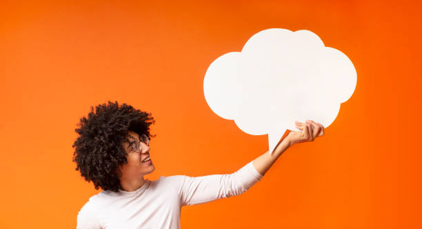 istock Positive african bushy guy looking up at white clean dialog bubble 1174448724