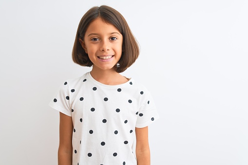 Young beautiful child girl wearing casual t-shirt standing over isolated white background with a happy and cool smile on face. Lucky person.