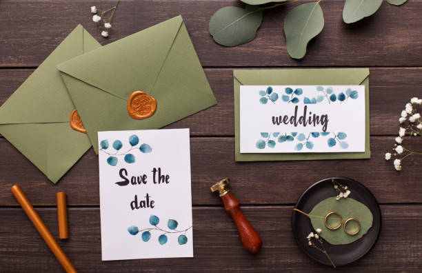 istock Preparing wedding invitations and folding envelopes on wood 1174450479