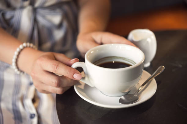 istock Young girl in a cafe with a coffee cup 1174451293