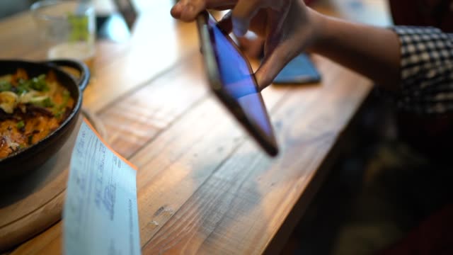 Man depositing check by phone in the restaurant