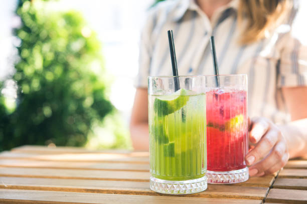 istock girl drinking cold drink beverage cocktail 1174451844