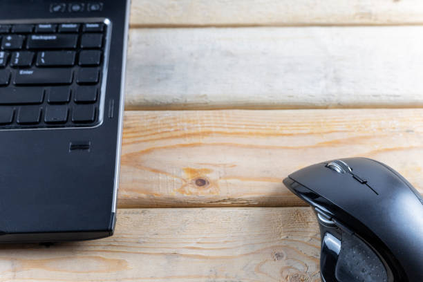istock Office concept. Mouse and laptop on wood table. With copy space for text or design. 1174452704