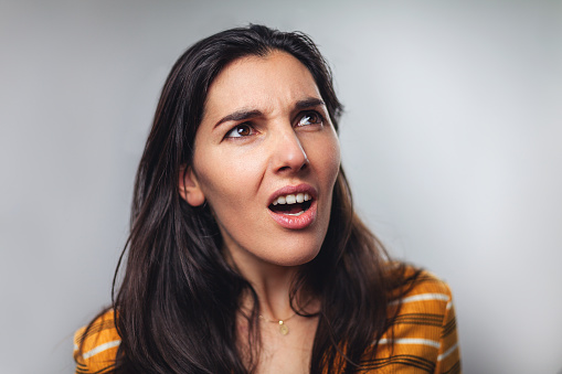 WTF! Head shot portrait of shocked frustrated young woman against to gray background