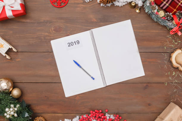 istock New Year 2019. Opened notebook isolated on table top view close-up 1174462132