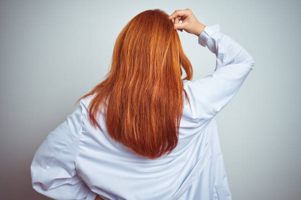 istock Young redhead doctor woman using stethoscope over white isolated background Backwards thinking about doubt with hand on head 1174467415