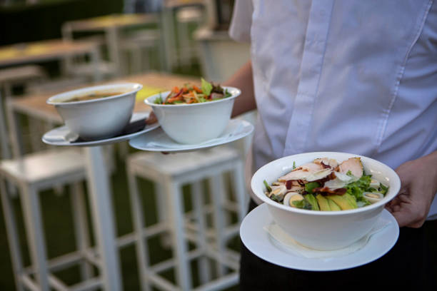 istock Waiter serving soup to customer 1174467568