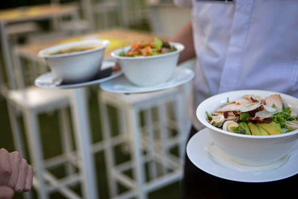 istock Waiter serving soup to customer 1174467609