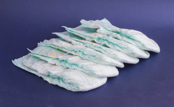 istock A stack of baby diapers on a blue background 1174467917