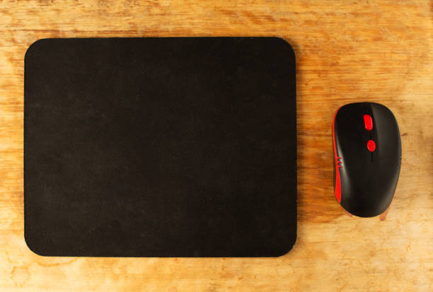 istock Computer mat and computer mouse on a wooden background, close-up, instrument 1174469079