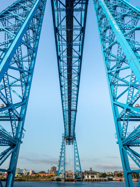 Under the the Middlesborough Transport Bridge Middlesbrough Transporter Bridge at sunrise. The Bridge carries people and cars over the River Tees in a suspended gondola middlesbrough stock pictures, royalty-free photos & images