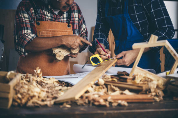 istock Background image of woodworking workshop: carpenters work table with different tools and wood cutting stand, vintage filter image 1174472069