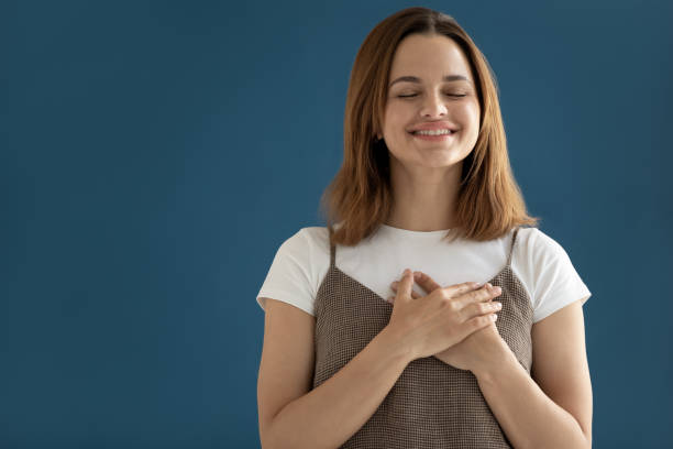 istock Woman putting hands on chest showing appreciation studio shot 1174472559