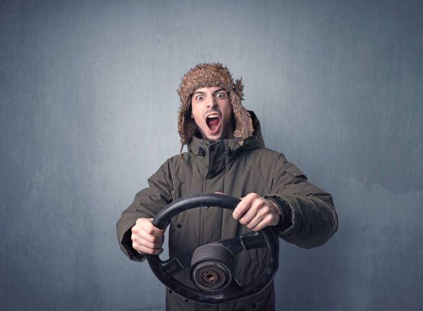 istock Man holding steering wheel 1174475026