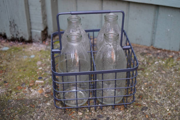 Milk bottle holder in front of a wooden gate
