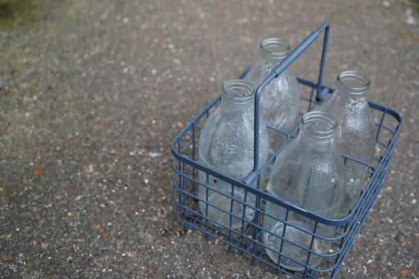 Close up of milk bottles and holder on a grey background