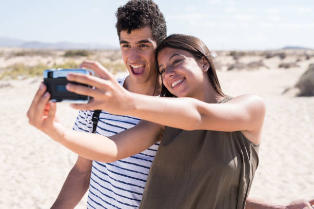 istock Young couple laughing and smiling at the camera 1174476673