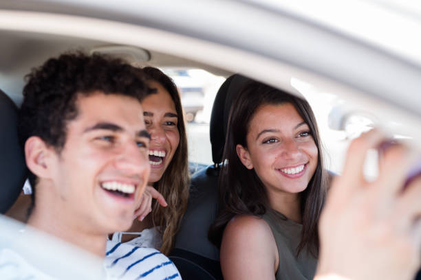 istock Young people in a car taking a photo 1174478484
