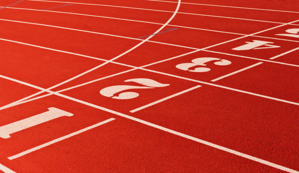 istock Stadium running track with red coating and numbers closeup 1174478682