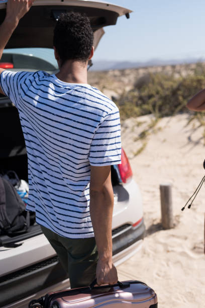 istock Man taking luggage out of a open car trunk 1174479204
