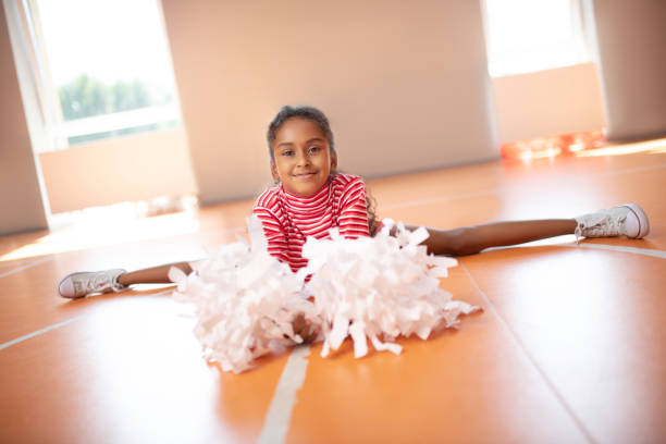 istock Girl wearing white sneakers doing leg split while stretching legs 1174479846