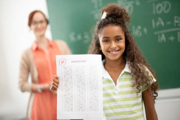 istock Curly girl feeling amazing after getting good mark 1174480662