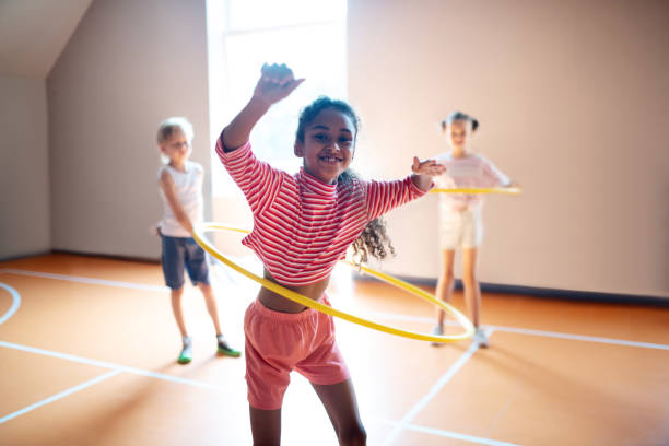istock Cheerful curly girl enjoying active PE lesson 1174480692