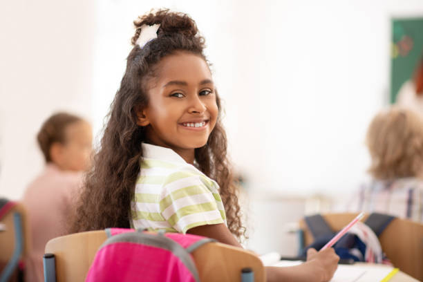 istock Cheerful girl feeling happy while attending school 1174480906