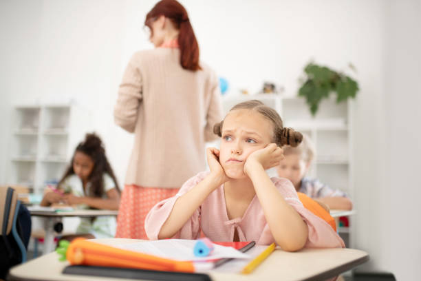 istock Dark-haired girl feeling sad after not writing the test 1174480980