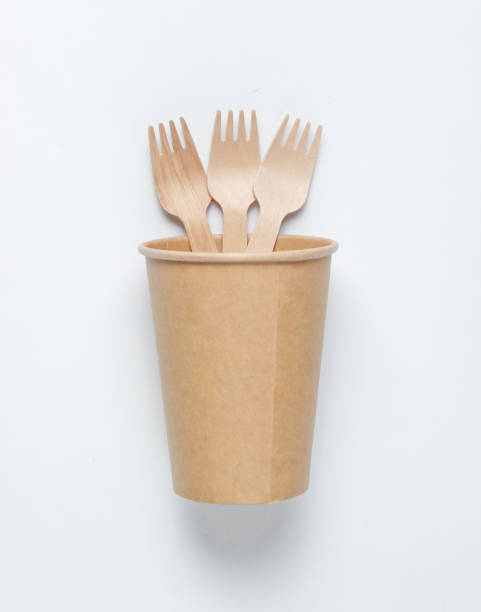istock Disposable empty coffee cup with forks of natural materials on white background. Eco friendly concept. Top view 1174482281