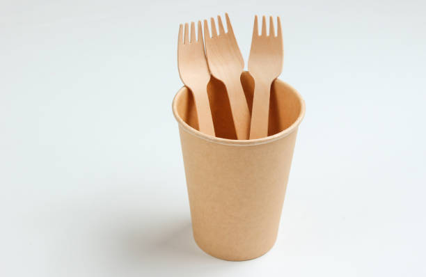 istock Disposable empty coffee cup with forks of natural materials on white background. Eco friendly concept. Top view 1174482312