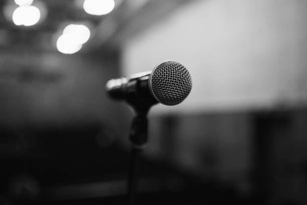 istock Microphone on stage. Electrical concert equipment. Old microphone on blurred background 1174482467