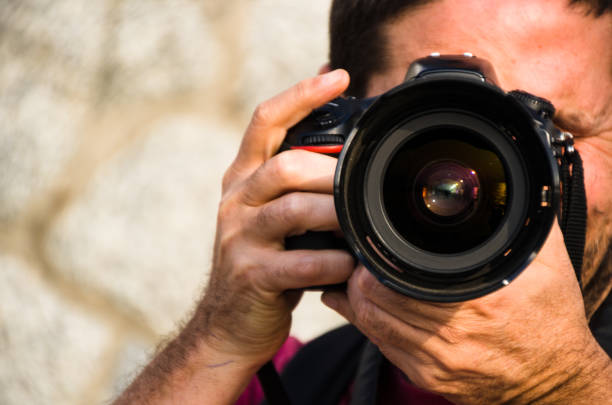 istock Photographer, taking photos with his professional camera 1174482481