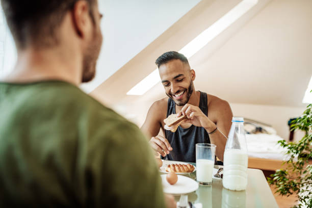 istock Gay couple eating healthy breakfast 1174491418