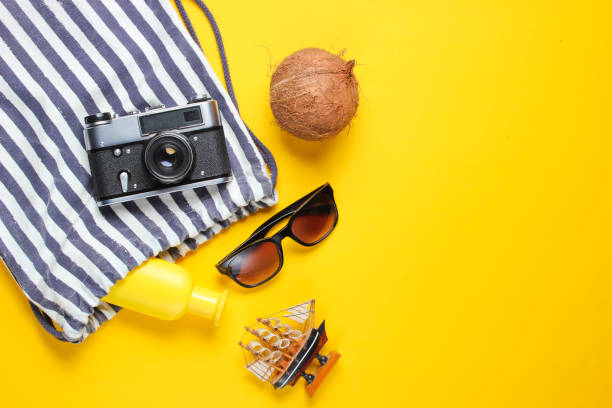 istock Beach vacation accessories on a yellow background. Summer creative background. Top view. Copy space 1174492047