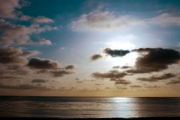 the sun sets over the Pacific Ocean in Laguna beach, CA