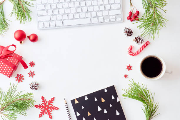 istock Flat lay christmas home office desk with pine branches and keyboard, christmas decorations  on a white background 1174498291