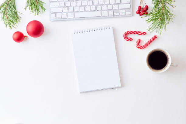 istock Mockup white notebook with pine branches and keyboard, christmas decorations  on a white background 1174498292