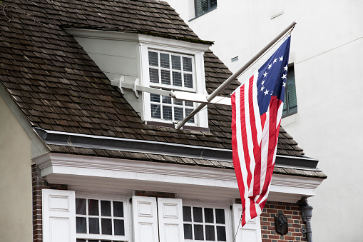 Philadelphia, USA - August 24, 2019. US flag hanging on the historic Betsy Rose House in the historic district of Philadelphia, Pennsylvania, USA