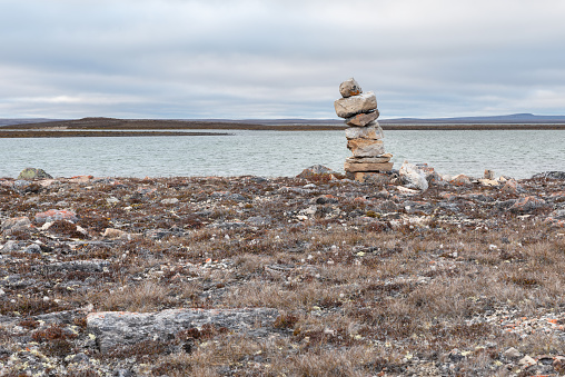 North Tea Lake at sunset in Algonquin Park with an inukshuk bout on its Rocky shore