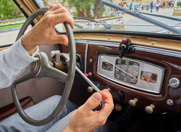 istock A male hands driving a classic car. 1174499442