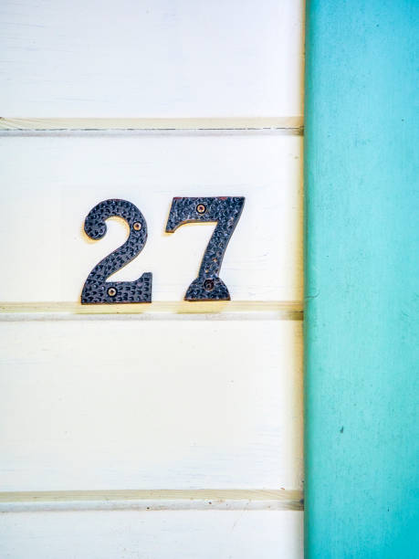 istock Vintage iron number 27 on a wooden wall. 1174499677