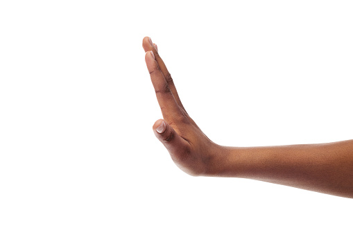 Side view of black female hand showing stop gesture, isolated on white background, copy space